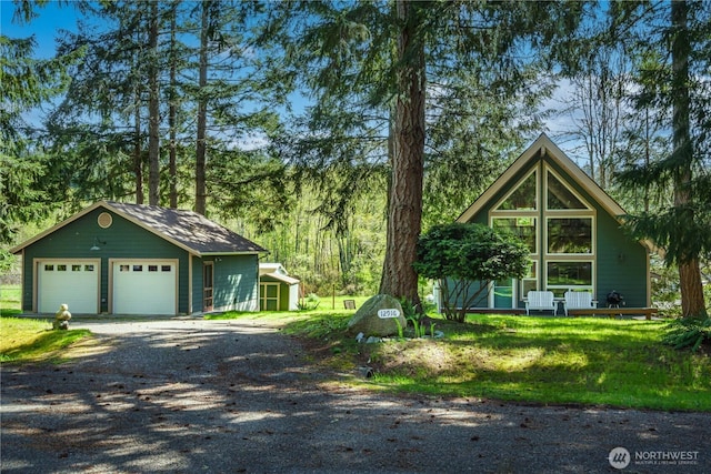 12916 91st Street Ct, Anderson Island, WA 98303 - chalet / cabin featuring an outdoor structure, gravel driveway, and a garage