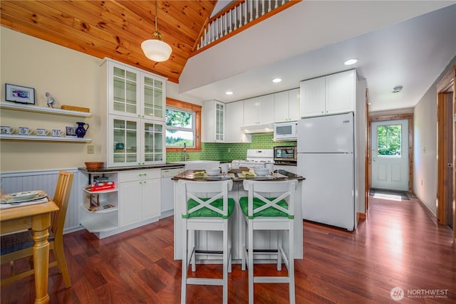 12916 91st Street Ct, Anderson Island, WA 98303 - kitchen with dark wood finished floors, a healthy amount of sunlight, open shelves, and white appliances