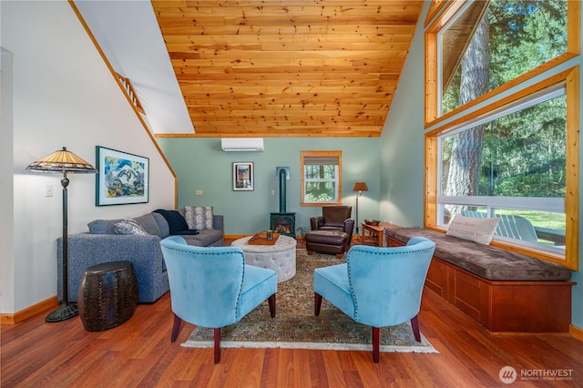 12916 91st Street Ct, Anderson Island, WA 98303 - living room featuring a wall mounted AC, a wood stove, high vaulted ceiling, and wooden ceiling
