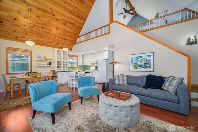 12916 91st Street Ct, Anderson Island, WA 98303 - living area featuring high vaulted ceiling, a ceiling fan, and wood finished floors