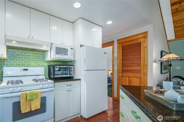 12916 91st Street Ct, Anderson Island, WA 98303 - kitchen with white cabinets, dark wood-style flooring, tasteful backsplash, white appliances, and under cabinet range hood