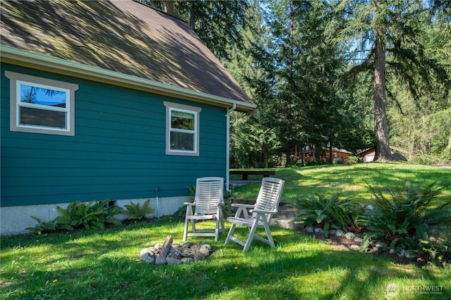12916 91st Street Ct, Anderson Island, WA 98303 - view of home's exterior featuring a lawn, roof with shingles, and central air condition unit