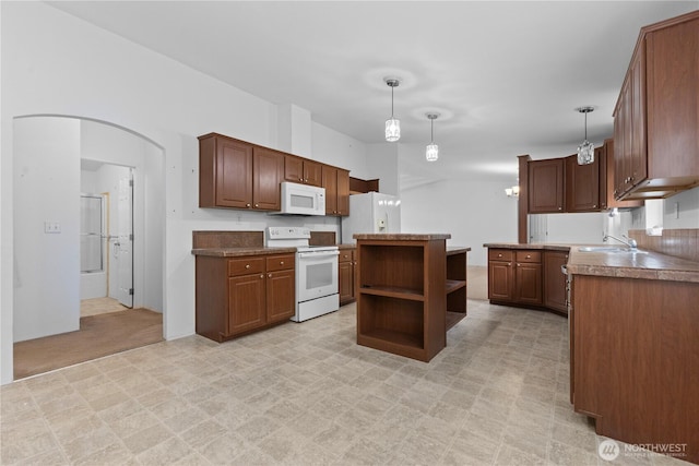 23914 66th St E Unit 33, Buckley, WA 98391 - kitchen featuring white appliances, open shelves, arched walkways, a kitchen island, and hanging light fixtures