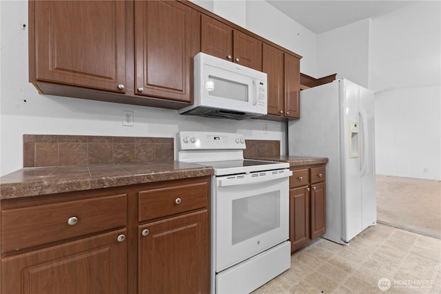 23914 66th St E Unit 33, Buckley, WA 98391 - kitchen featuring white appliances, brown cabinetry, and light flooring