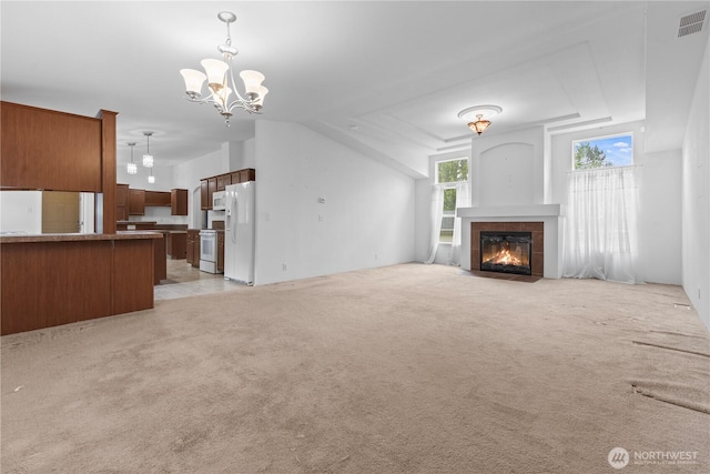 23914 66th St E Unit 33, Buckley, WA 98391 - unfurnished living room with a chandelier, light carpet, and a tile fireplace