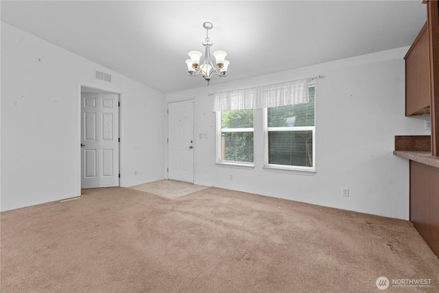 23914 66th St E Unit 33, Buckley, WA 98391 - unfurnished dining area featuring a chandelier and light colored carpet