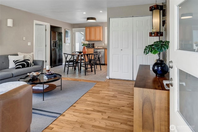 living room featuring light wood finished floors and recessed lighting