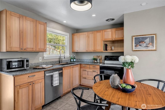 kitchen with stainless steel appliances, a sink, recessed lighting, light brown cabinets, and light tile patterned floors
