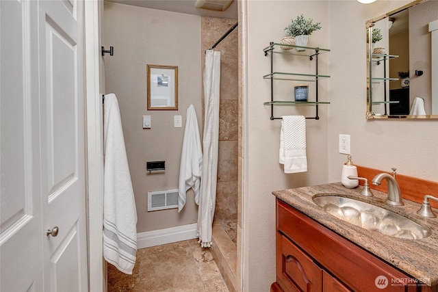 full bathroom with baseboards, a shower stall, visible vents, and vanity