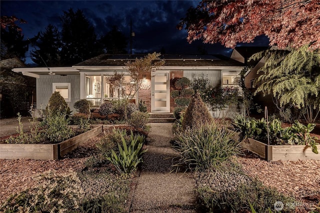 view of front facade featuring a vegetable garden