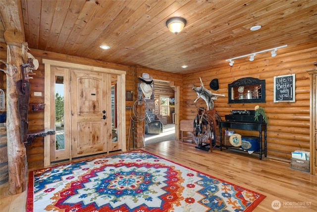foyer entrance with hardwood / wood-style floors, recessed lighting, rustic walls, and wood ceiling