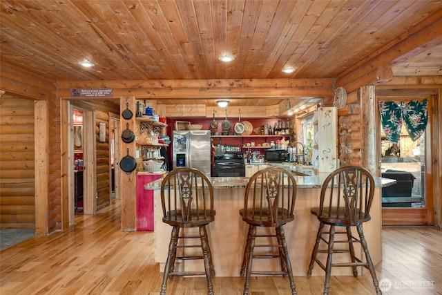 bar with light wood finished floors, wet bar, wood ceiling, stainless steel refrigerator with ice dispenser, and log walls