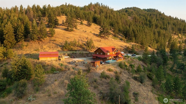 birds eye view of property with a forest view