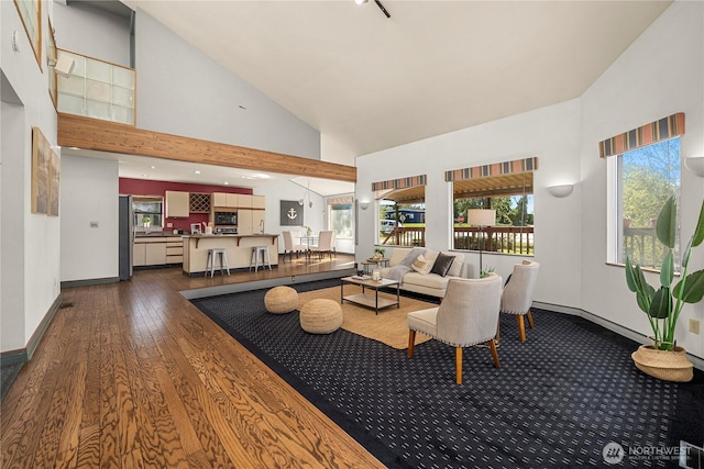 5201 Hyada Blvd NE, Tacoma, WA 98422 - living area featuring high vaulted ceiling, dark wood finished floors, and baseboards