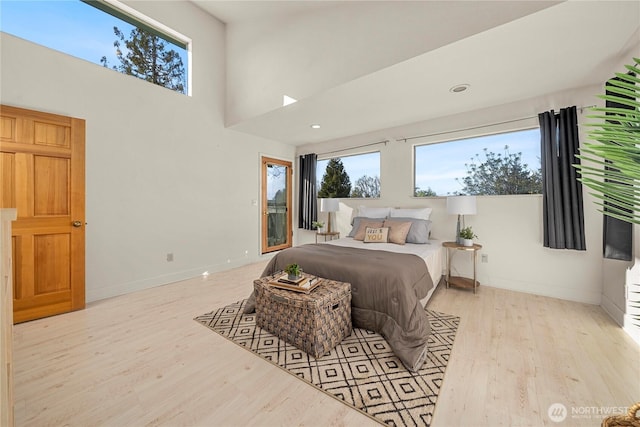 5201 Hyada Blvd NE, Tacoma, WA 98422 - bedroom with baseboards, a towering ceiling, wood finished floors, and multiple windows