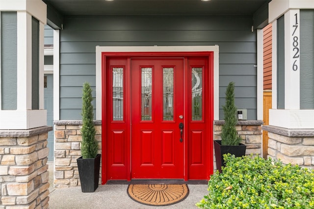 view of exterior entry featuring covered porch