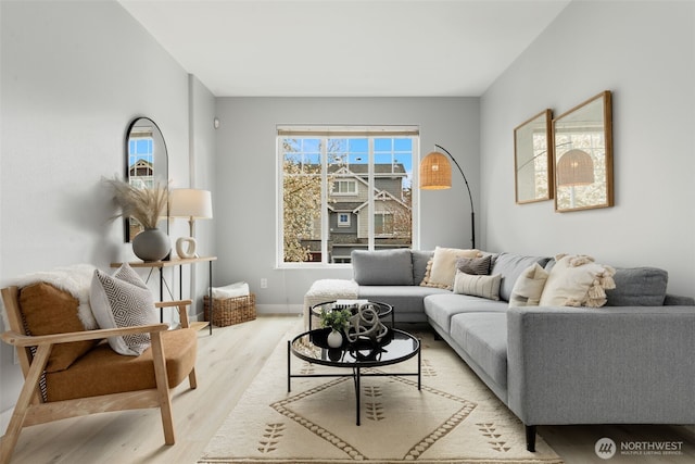 living area with wood finished floors and baseboards