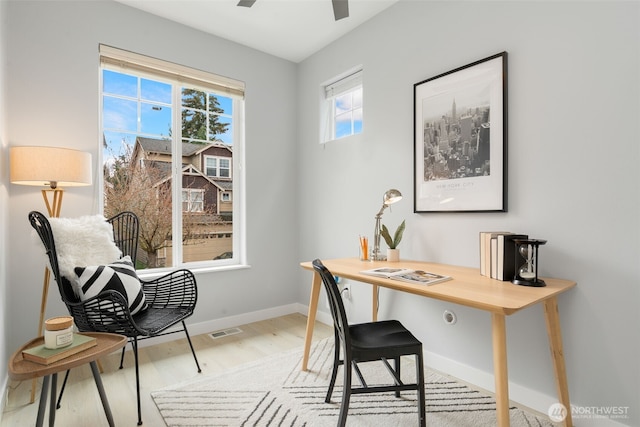 office featuring light wood-style flooring, baseboards, and ceiling fan