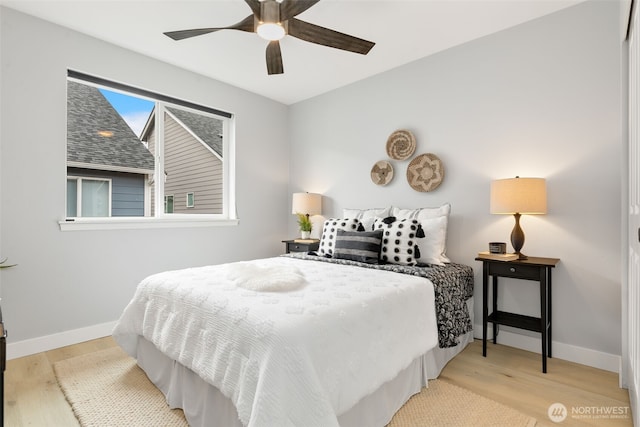 bedroom with wood finished floors, baseboards, and a ceiling fan