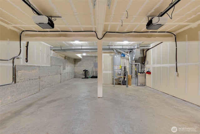 garage featuring water heater, a garage door opener, and heating unit