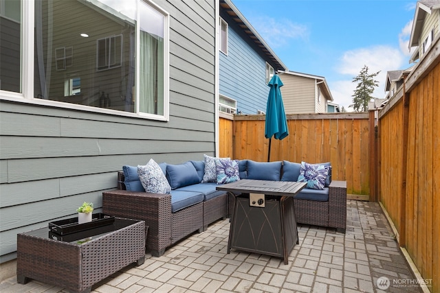 view of patio with an outdoor living space and a fenced backyard