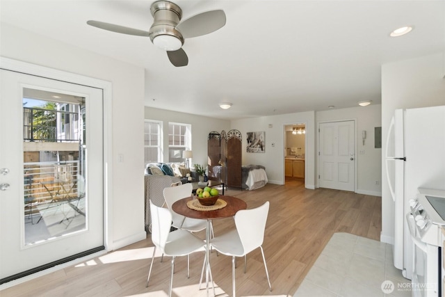 dining space featuring recessed lighting, light wood-type flooring, a ceiling fan, and baseboards