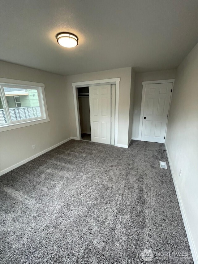 unfurnished bedroom featuring baseboards and carpet flooring