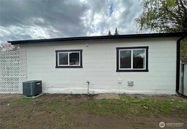 view of side of home with central AC