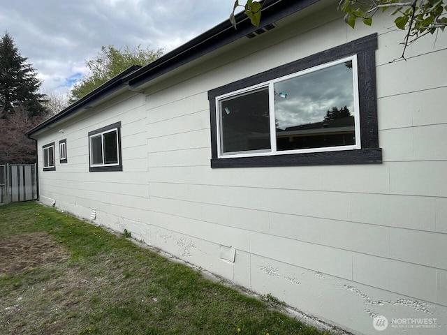 view of side of property with a yard
