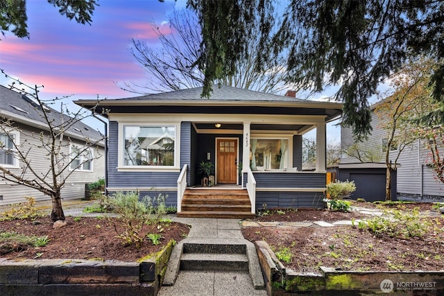 4642 Eastern Ave N, Seattle, WA 98103 - view of front facade with covered porch, an outdoor structure, and a garage