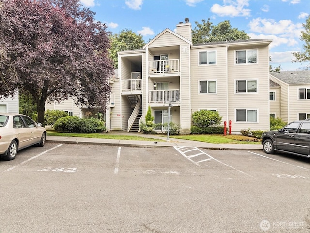 975 Aberdeen Ave NE Unit E103, Renton, WA 98056 - view of building exterior with uncovered parking and stairs