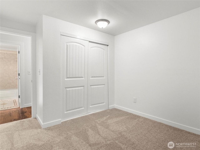 975 Aberdeen Ave NE Unit E103, Renton, WA 98056 - unfurnished bedroom featuring carpet floors, a closet, and baseboards