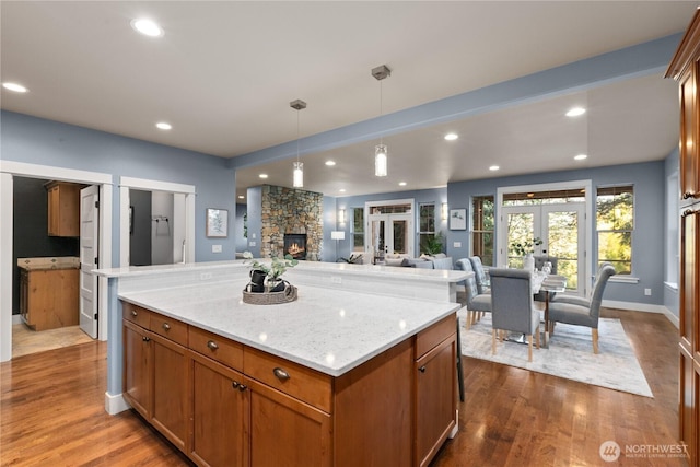 kitchen featuring open floor plan, dark wood-type flooring, decorative light fixtures, a center island, and french doors