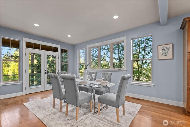 dining room featuring baseboards, light wood-type flooring, and recessed lighting