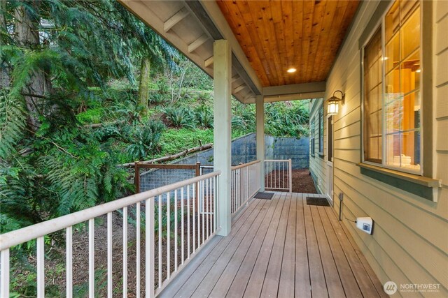 wooden terrace featuring fence