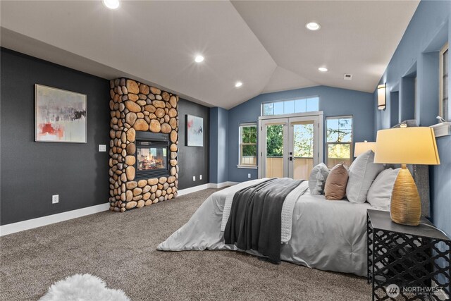 bedroom with carpet, lofted ceiling, recessed lighting, a fireplace, and french doors