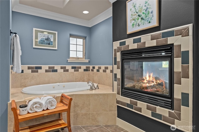bathroom featuring ornamental molding, a garden tub, a tile fireplace, and tile patterned flooring