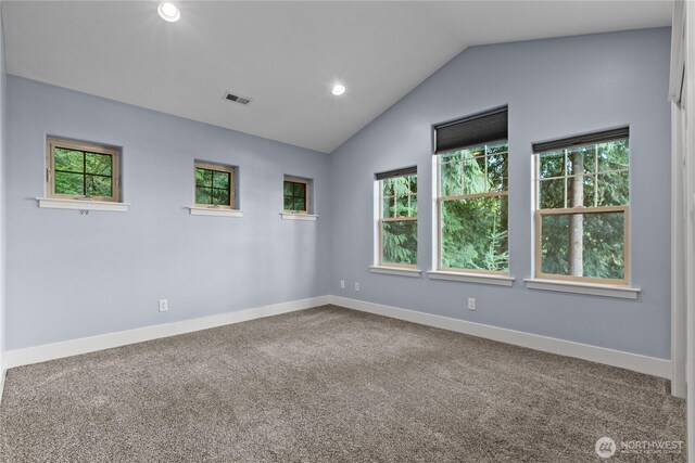 empty room with carpet floors, lofted ceiling, baseboards, and recessed lighting