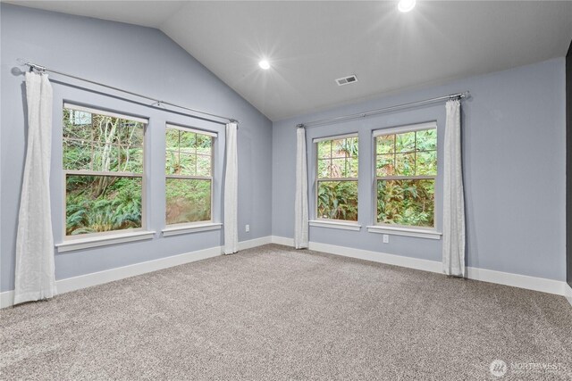 carpeted spare room with vaulted ceiling, plenty of natural light, recessed lighting, and baseboards