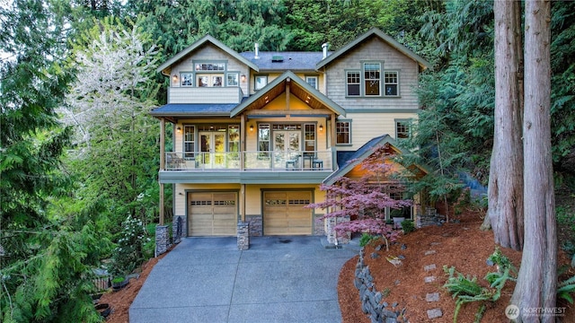 view of front of home featuring a balcony, concrete driveway, stone siding, and an attached garage
