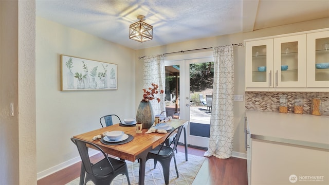 19134 SE May Valley Rd, Issaquah, WA 98027 - dining room with wood finished floors, baseboards, french doors, and a textured ceiling