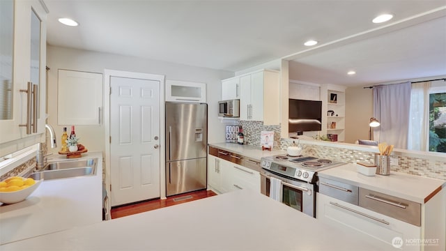 19134 SE May Valley Rd, Issaquah, WA 98027 - kitchen featuring stainless steel appliances, a sink, backsplash, light countertops, and white cabinets