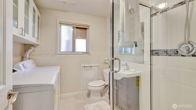 19134 SE May Valley Rd, Issaquah, WA 98027 - bathroom with washer and dryer, a shower stall, toilet, vanity, and baseboards