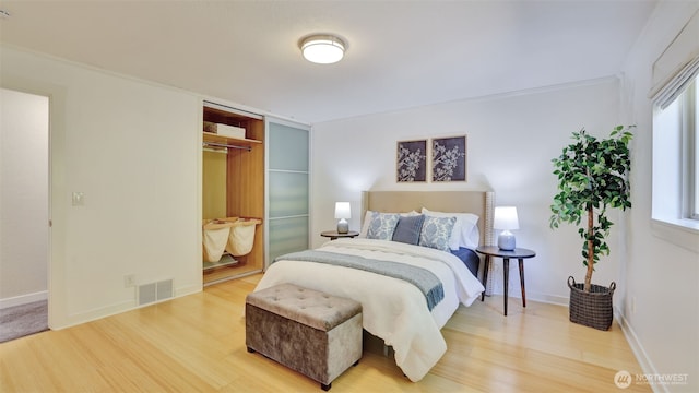 19134 SE May Valley Rd, Issaquah, WA 98027 - bedroom featuring wood finished floors, a closet, and baseboards