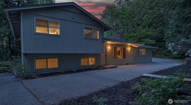 19134 SE May Valley Rd, Issaquah, WA 98027 - rear view of house with a chimney, driveway, and a patio