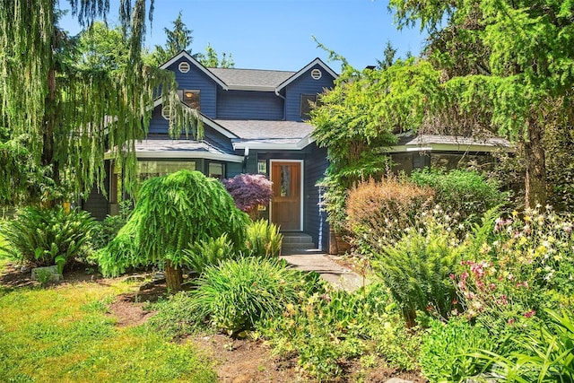 26032 5th Ave NE, Arlington, WA 98223 - view of property hidden behind natural elements with a shingled roof and entry steps