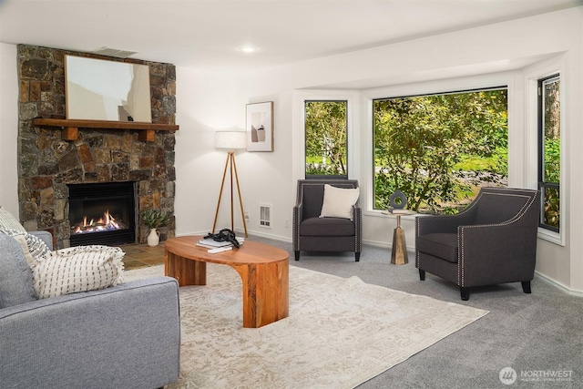 26032 5th Ave NE, Arlington, WA 98223 - carpeted living area featuring a stone fireplace and baseboards