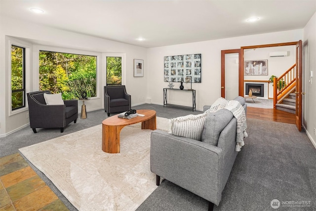 26032 5th Ave NE, Arlington, WA 98223 - carpeted living room featuring a fireplace, a wall mounted AC, stairway, and recessed lighting
