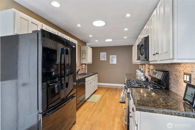 kitchen featuring recessed lighting, white cabinetry, black appliances, and tasteful backsplash