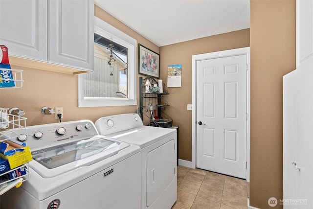 laundry room with separate washer and dryer, baseboards, light tile patterned floors, and cabinet space